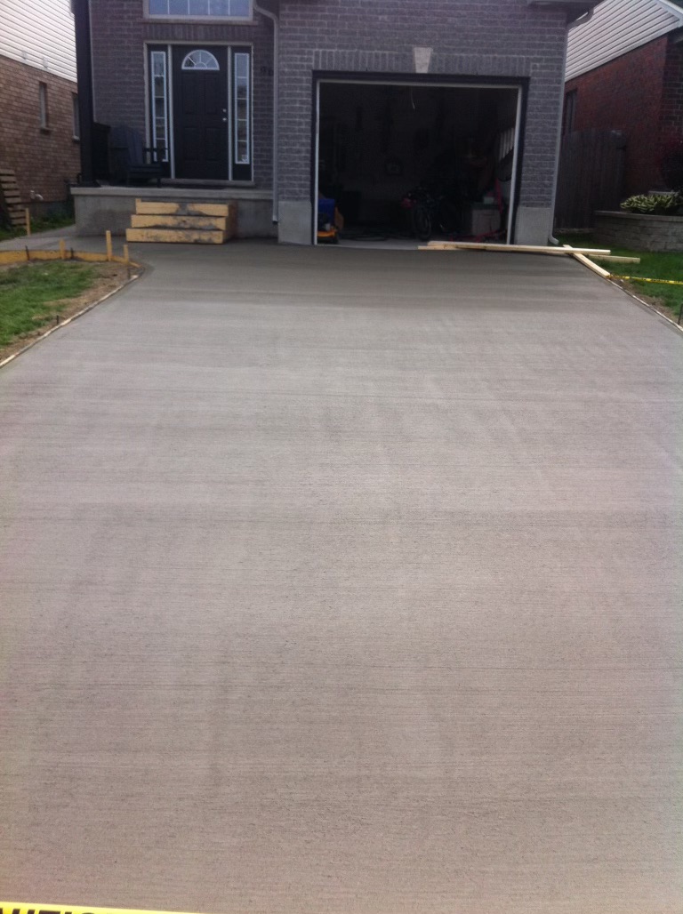 A brushed concrete driveway performed by Ultimate Touch Concrete, a concrete company in London Ontario specializing in both residential and commercial concrete services.