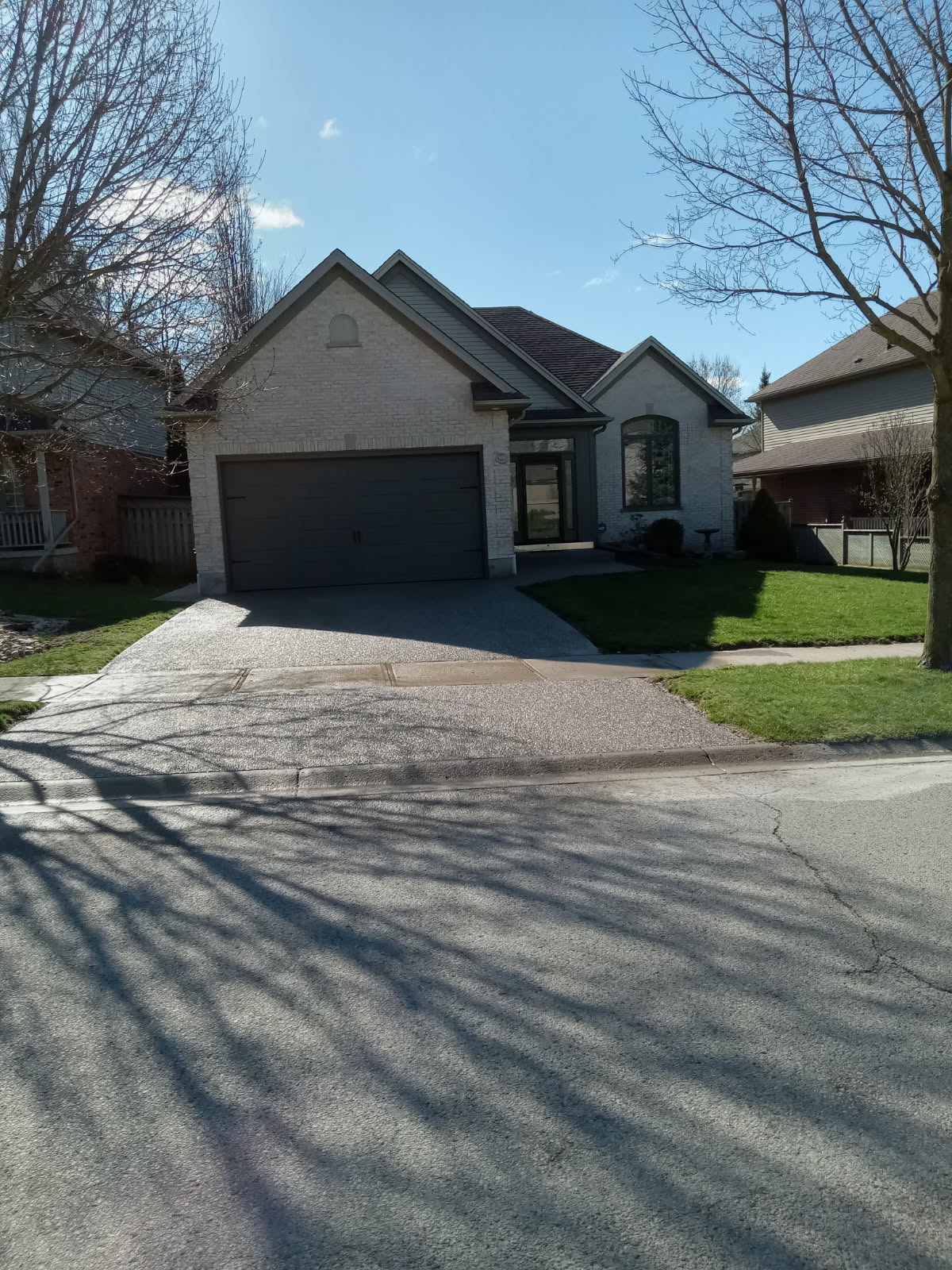 An exposed aggregate concrete driveway performed by Ultimate Touch Concrete, a concrete company in London Ontario specializing in both residential and commercial concrete services.